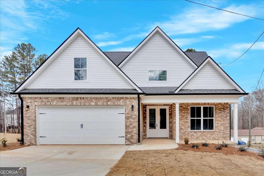 view of front of home with french doors and a garage