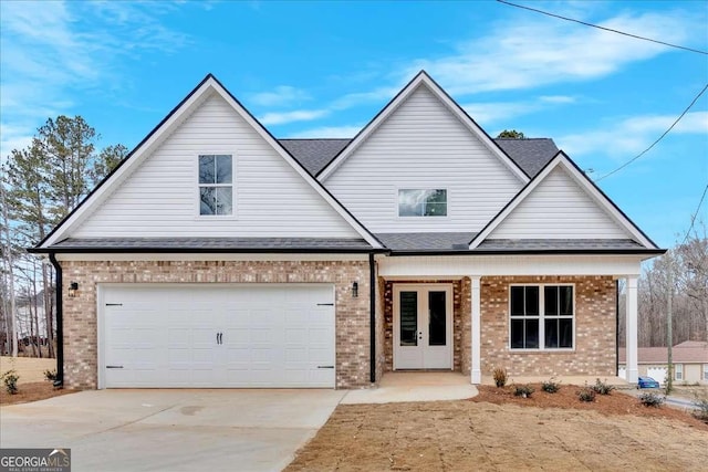 view of front of home with french doors and a garage