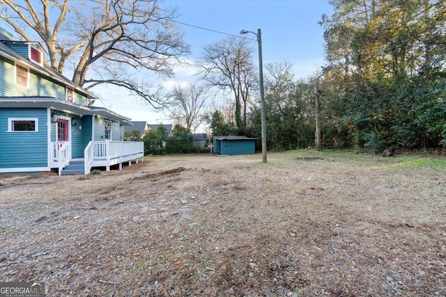 view of yard featuring a shed and a deck