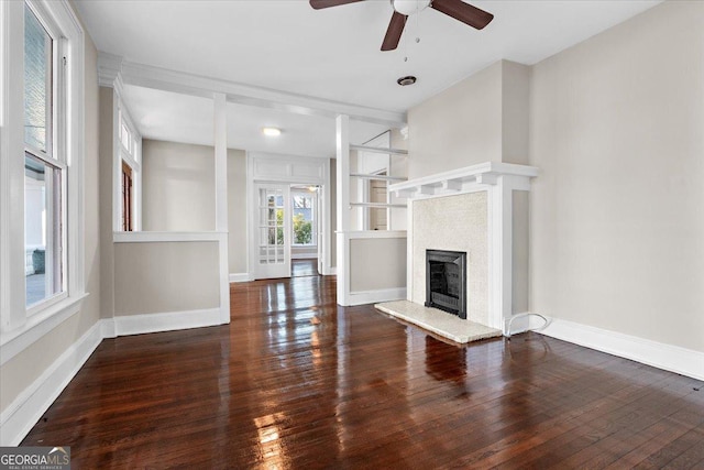 unfurnished living room with dark wood-type flooring and ceiling fan