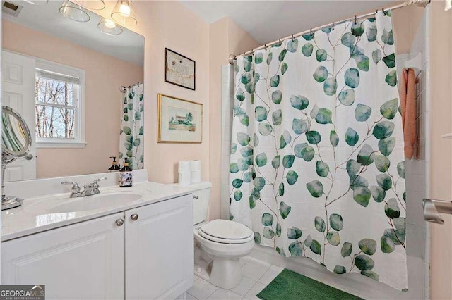 bathroom with walk in shower, vanity, toilet, and tile patterned flooring