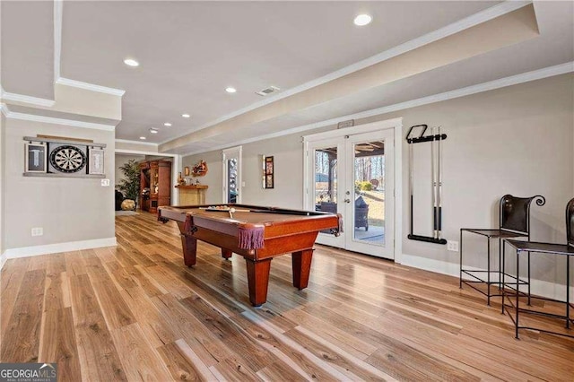 game room with ornamental molding, pool table, light hardwood / wood-style floors, a raised ceiling, and french doors