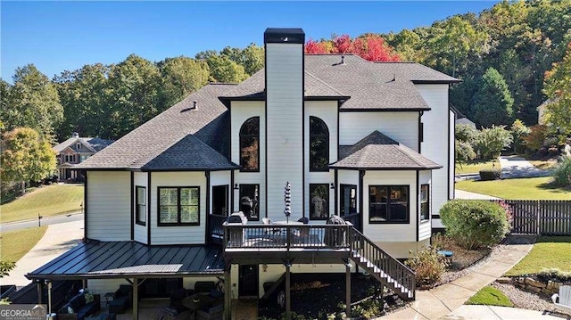 rear view of property with a wooden deck