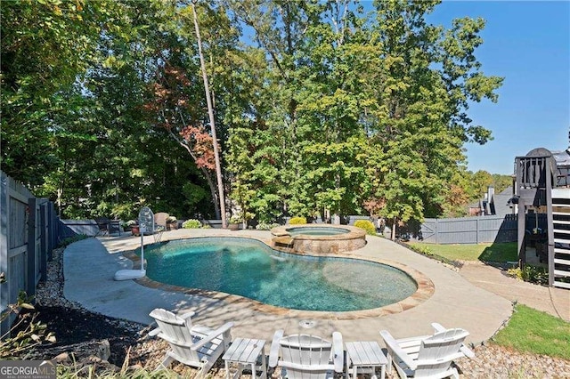 view of pool with an in ground hot tub