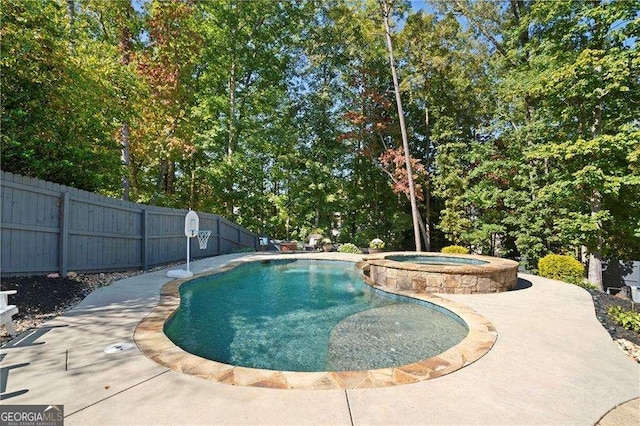 view of swimming pool with an in ground hot tub and a patio