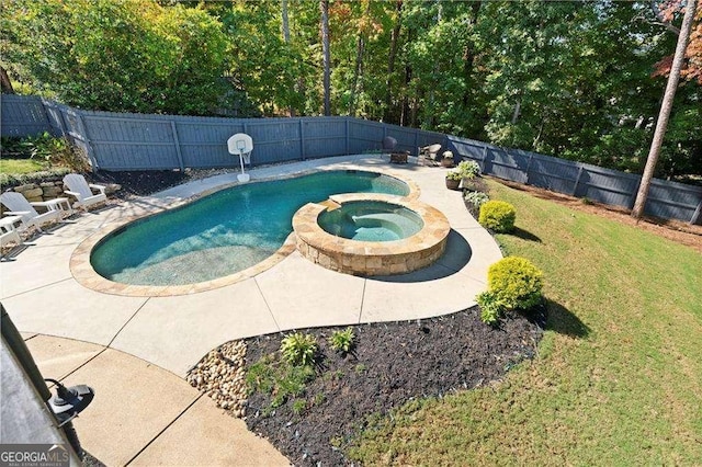 view of swimming pool featuring a yard, a patio area, and an in ground hot tub