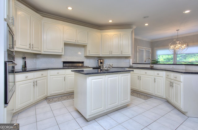 kitchen with a center island, white cabinets, and backsplash