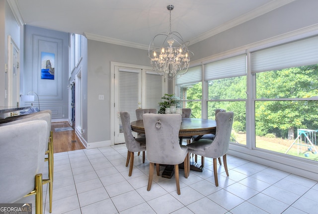 tiled dining area with ornamental molding and a notable chandelier