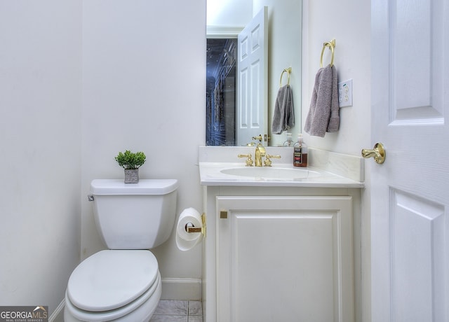 bathroom featuring vanity, tile patterned flooring, and toilet