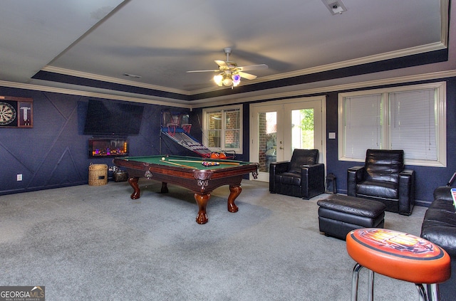 rec room with a raised ceiling, crown molding, carpet, and french doors