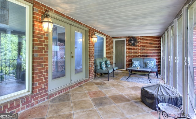 unfurnished sunroom with french doors