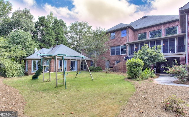 exterior space featuring a playground and a lawn