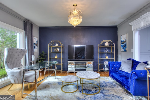 living room with hardwood / wood-style floors, crown molding, and a chandelier