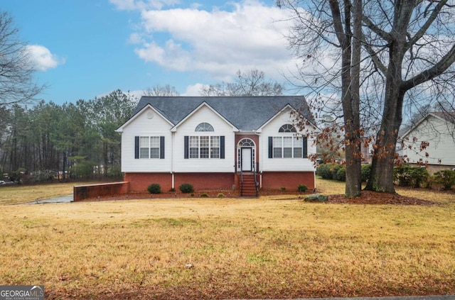 bi-level home with a front lawn