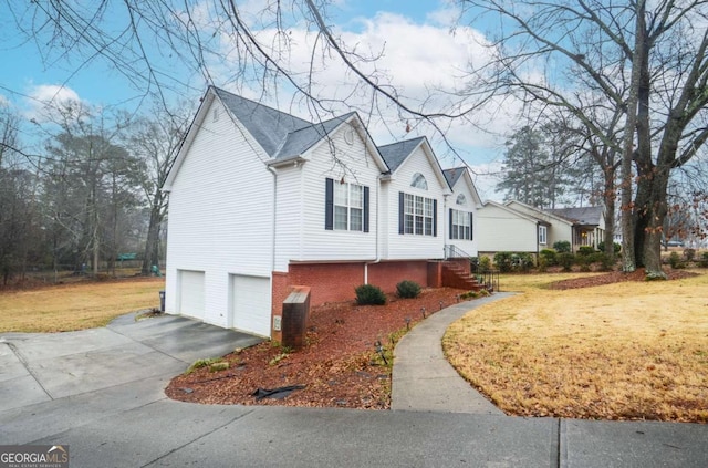 view of side of property with a garage and a lawn