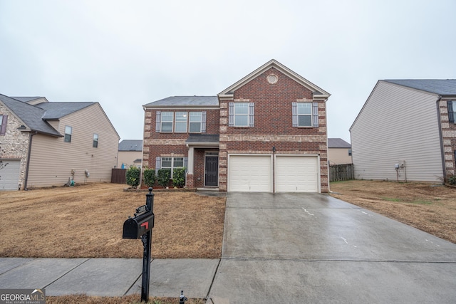 view of front of property featuring a garage and a front yard