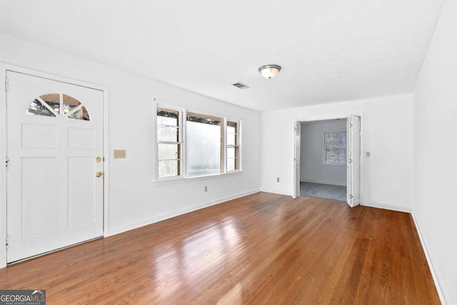 entryway with hardwood / wood-style flooring and a healthy amount of sunlight