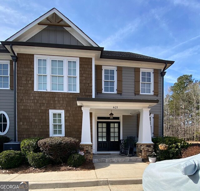 view of front of home with central air condition unit and french doors