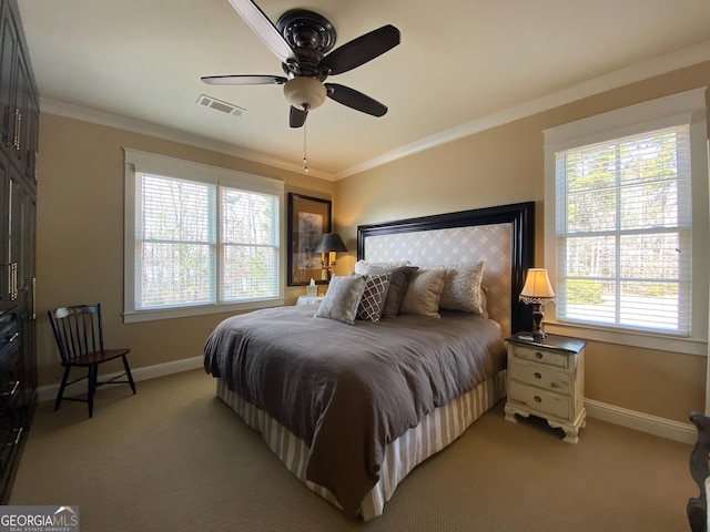 carpeted bedroom with ornamental molding and ceiling fan