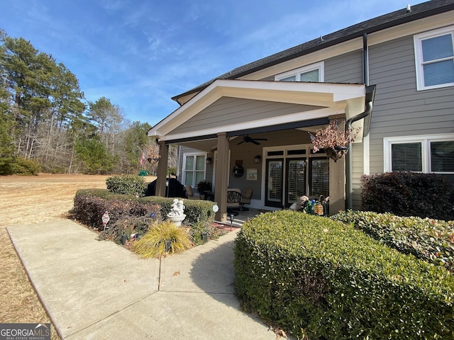 entrance to property featuring ceiling fan and a patio area