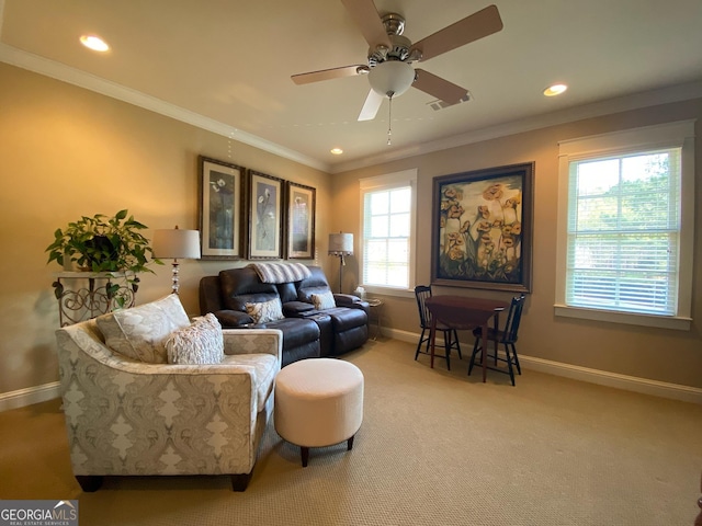 carpeted living room featuring crown molding and ceiling fan