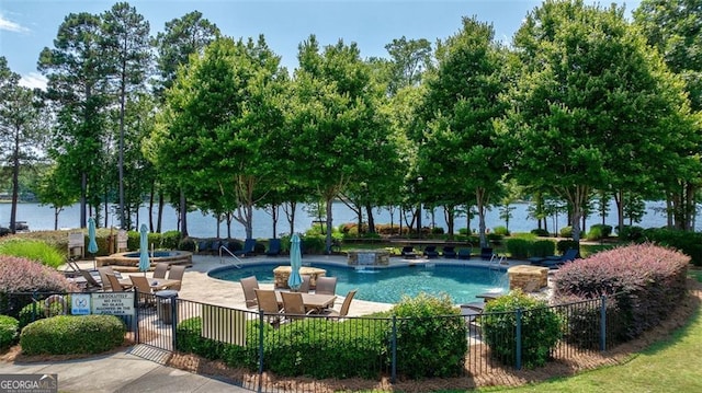 view of pool featuring a water view, pool water feature, and a patio area