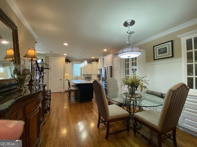 dining room featuring crown molding and dark hardwood / wood-style floors