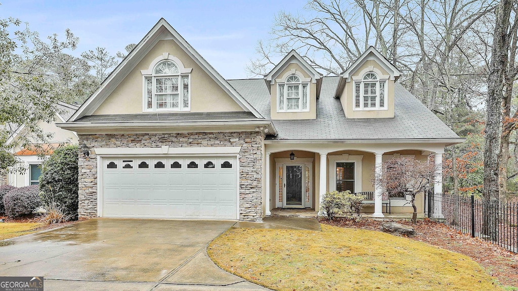 view of front of home with a porch and a garage