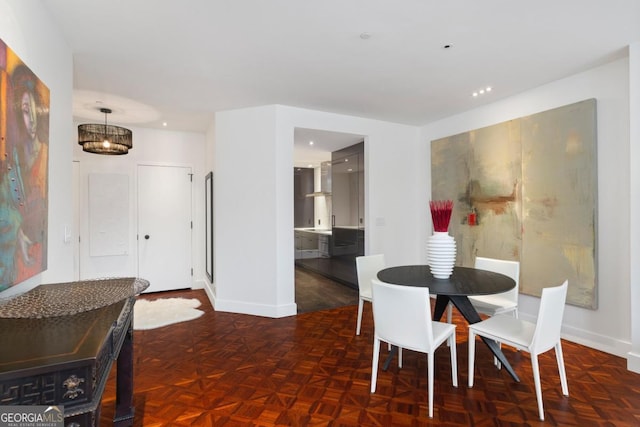 dining space with dark parquet floors