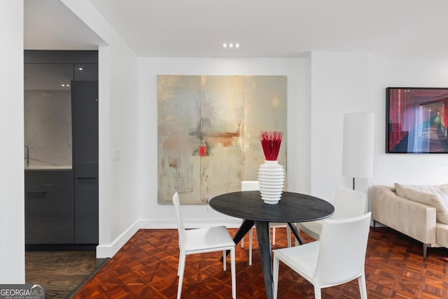 dining area with dark parquet floors