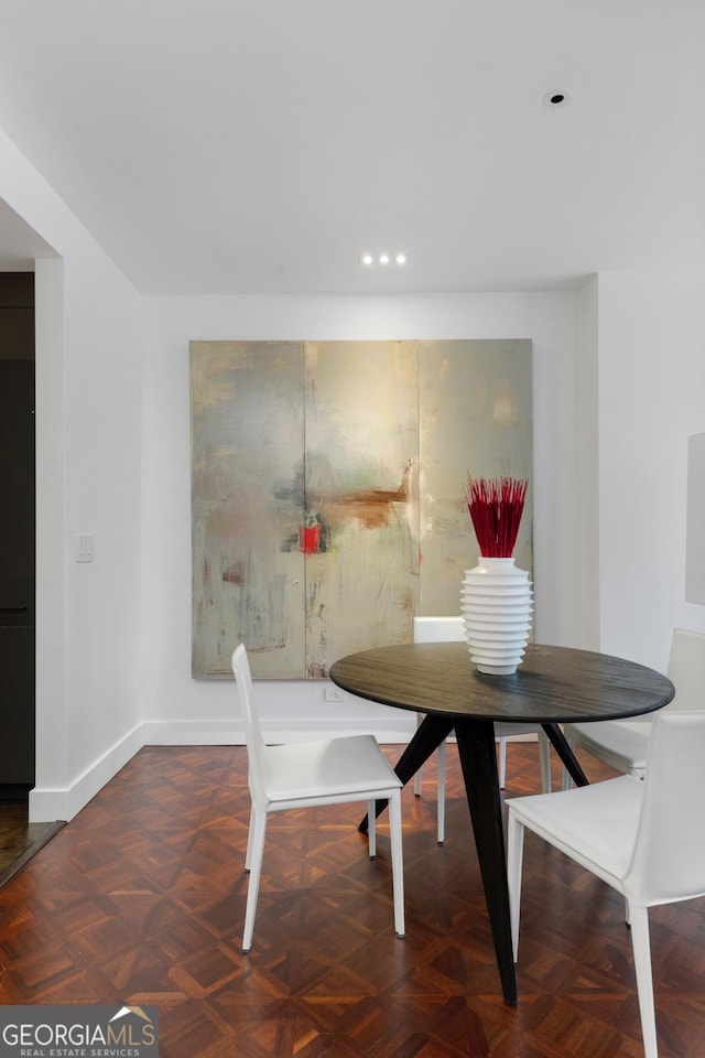 dining room featuring dark parquet floors