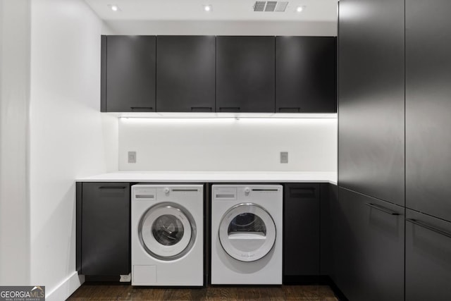 laundry room featuring cabinets and washer and clothes dryer