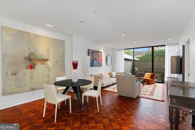 dining room with a wall of windows and dark parquet floors