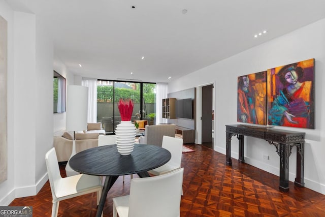 dining space featuring expansive windows and parquet flooring