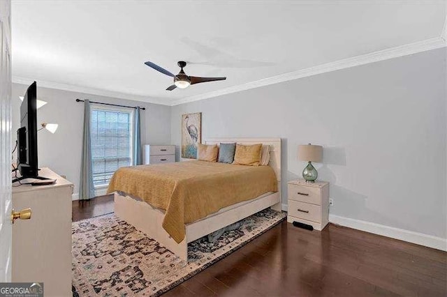 bedroom featuring a ceiling fan, crown molding, baseboards, and wood finished floors