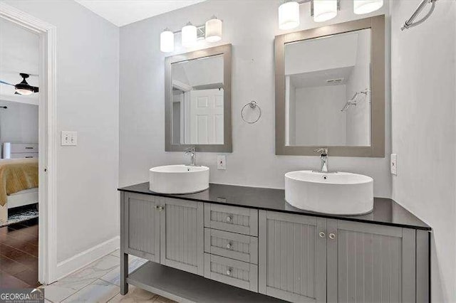 bathroom featuring double vanity, marble finish floor, ensuite bath, and a sink