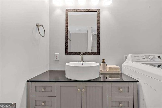 bathroom featuring washer / clothes dryer and vanity