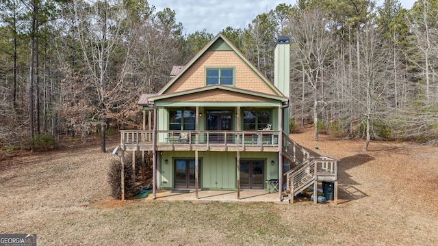 rear view of property with a patio and a deck