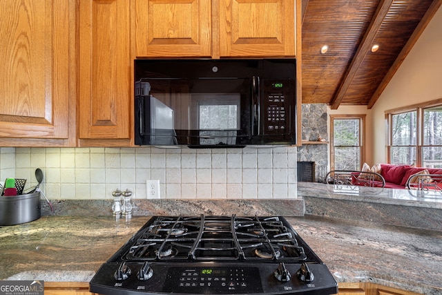 kitchen featuring wood ceiling, vaulted ceiling with beams, black appliances, decorative backsplash, and dark stone counters