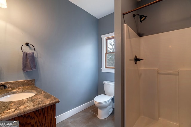 bathroom with tile patterned floors, vanity, toilet, and a shower