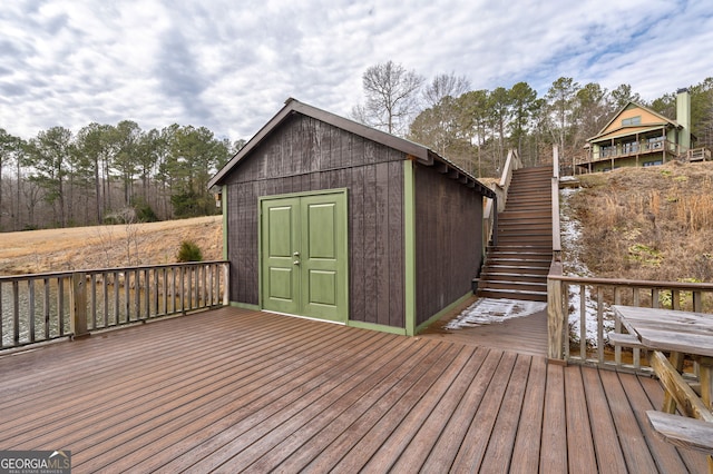 wooden terrace with a storage shed