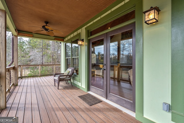 unfurnished sunroom with wooden ceiling and ceiling fan