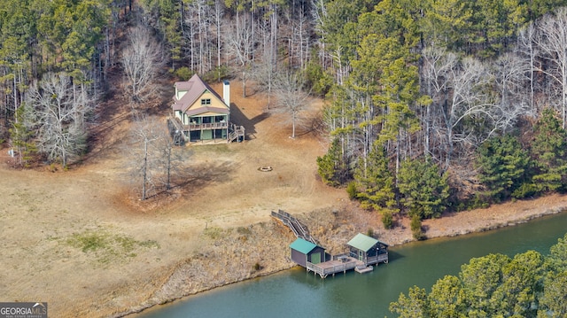 birds eye view of property with a water view