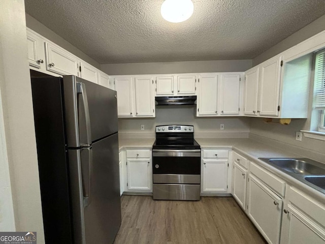 kitchen with white cabinetry, dark hardwood / wood-style flooring, stainless steel appliances, and a textured ceiling