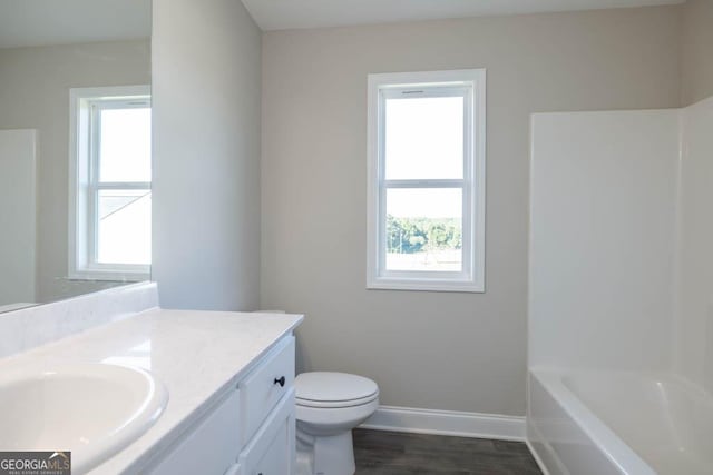 full bathroom featuring vanity, a healthy amount of sunlight, and toilet