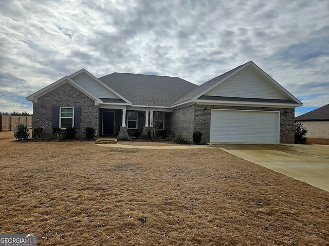 view of front of property with a garage and a front lawn