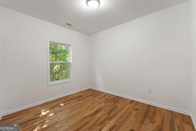 unfurnished room featuring wood-type flooring