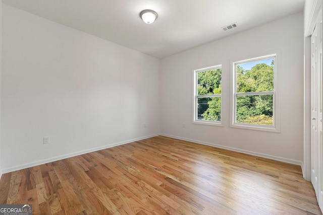 unfurnished room with light wood-type flooring