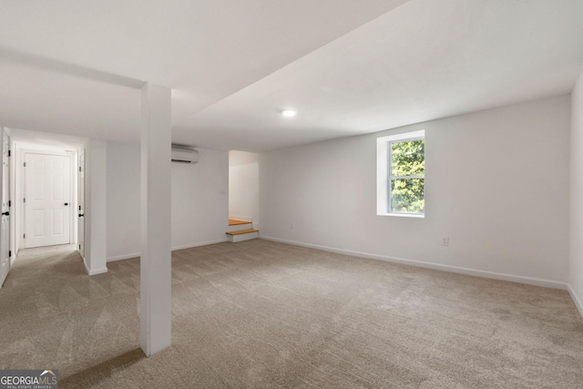 basement featuring light colored carpet and a wall mounted AC