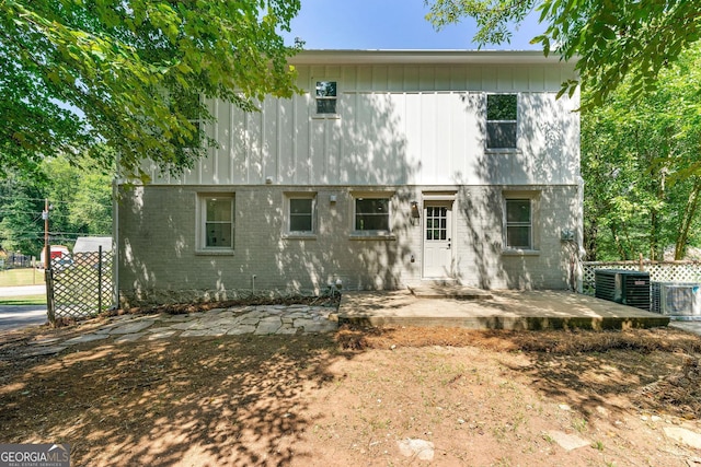 view of front of house with a patio area and central air condition unit